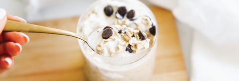 cup with creamy oatmeal and chocolate chips as garnish